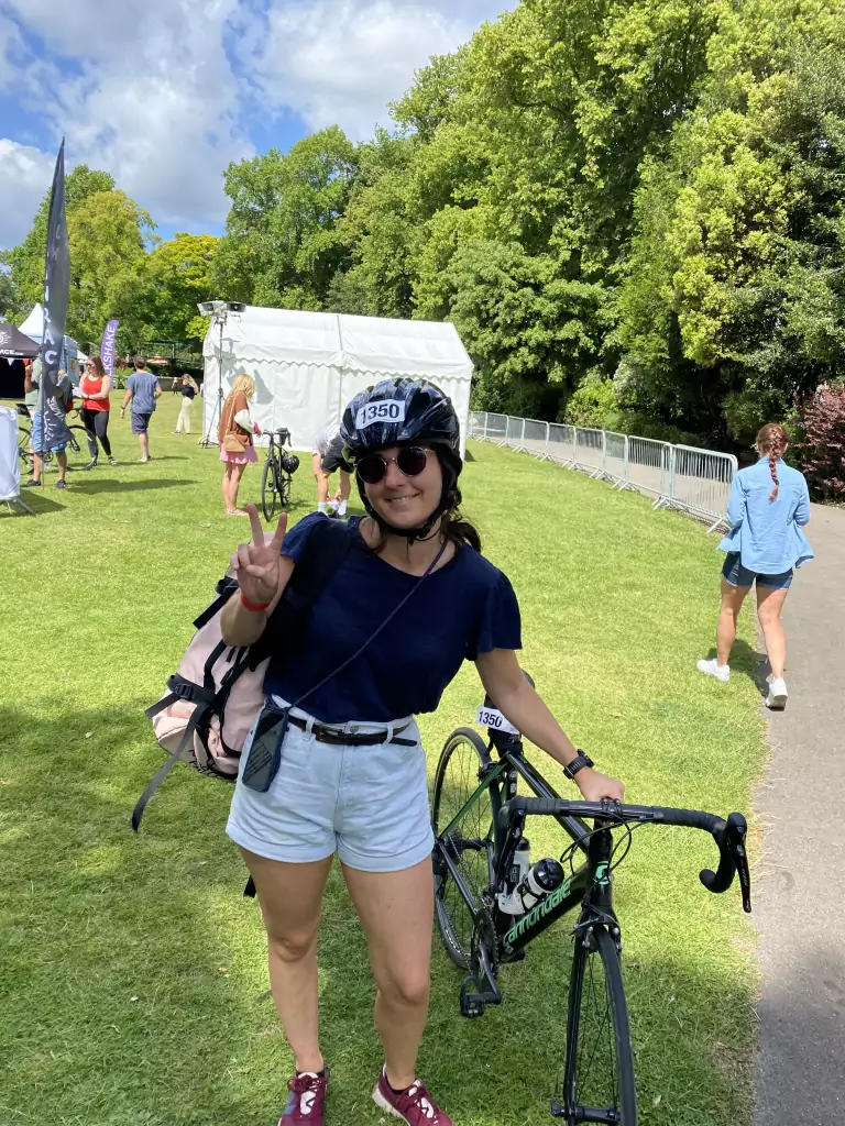 Thais giving the thumbs up sign. Bike helmet on with sunglasses. Looking effortlessly cool